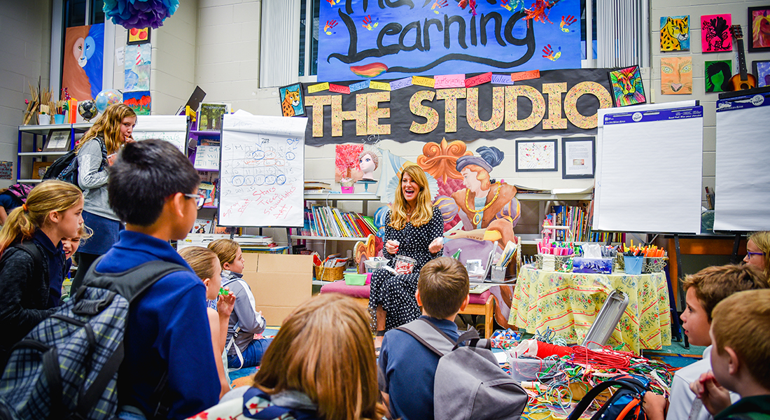 Cindy Bohn doing an art lesson with students